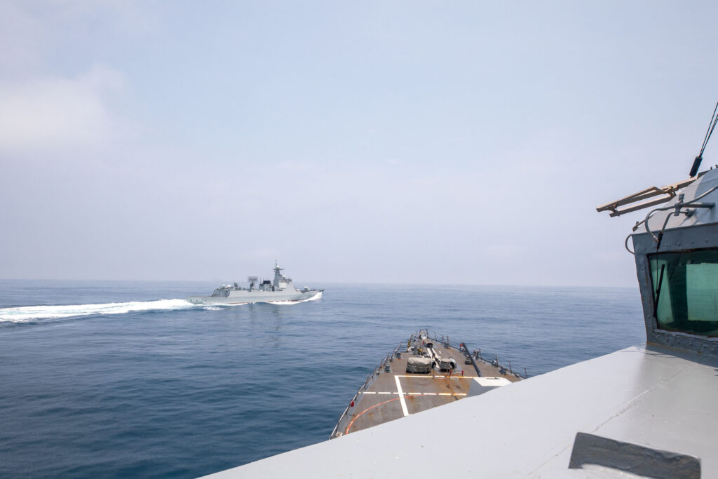 This handout photo taken on June 3, 2023 by the US Navy shows the Arleigh Burke-class guided-missile destroyer USS Chung-Hoon observing the Chinese PLA Navy vessel Luyang III (top) while on a transit through the Taiwan Strait with the Royal Canadian Navy's HMCS Montreal. (Photo by Andre T. Richard / US NAVY / AFP) 