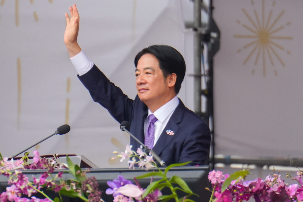 Taiwan's President Lai Ching-te waves at the podium during National Day celebrations in front of the Presidential Office in Taipei on October 10, 2024. (Photo by WALID BERRAZEG / AFP)