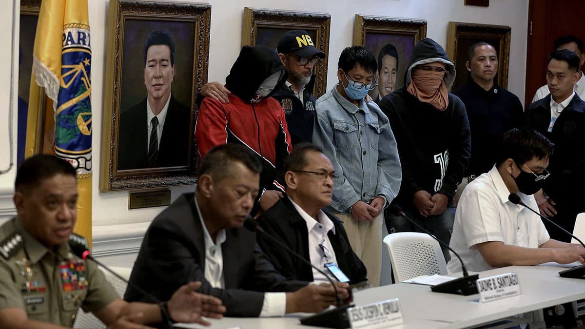 SLEEPER AGENT Justice Secretary Jesus Crispin Remulla (seated, second from left), flanked by AFP chief of staff Gen. Romeo Brawner Jr. and NBI Director JaimeSantiago, on Monday presents to reporters a suspected Chinese spy and his two Filipino cohorts who were arrested for alleged espionage. —RICHARD A. REYES